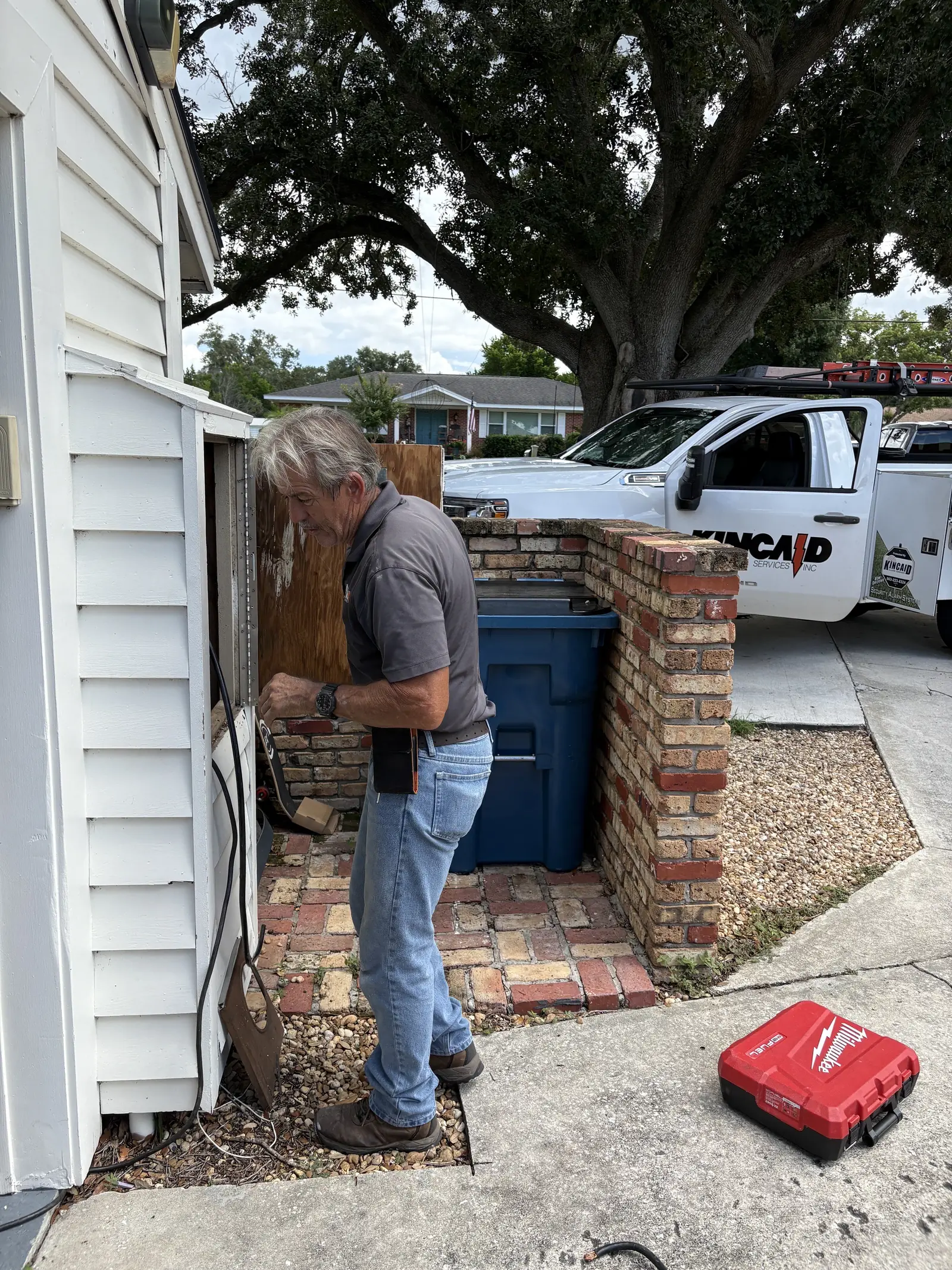 Kincaid Electric electrician servicing an outdoor electrical meter next to the work truck