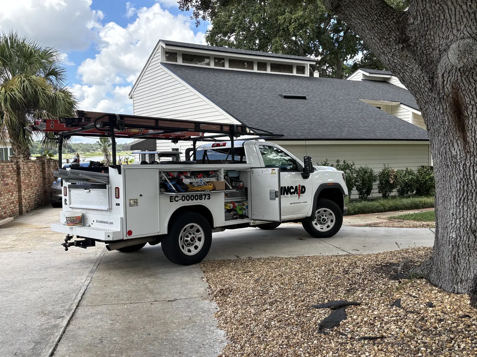 Kincaid Electric service truck with ladder rack parked in a Lake Wales driveway