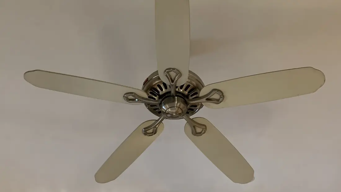 Five blade ceiling fan mounted on a white ceiling