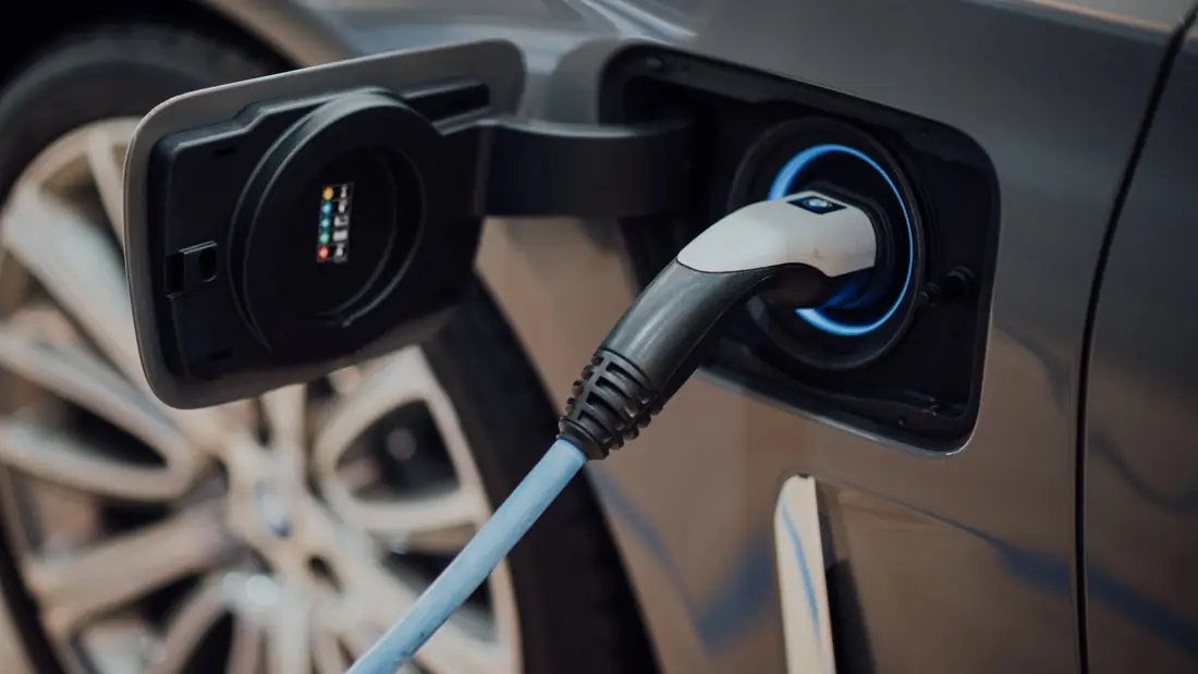 Electric vehicle charger plugged into a car charging port