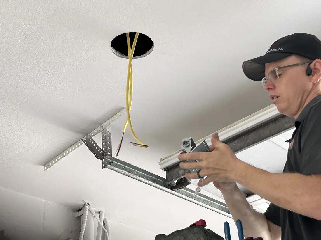 Kincaid Electric electrician installing a recessed light fixture in a ceiling
